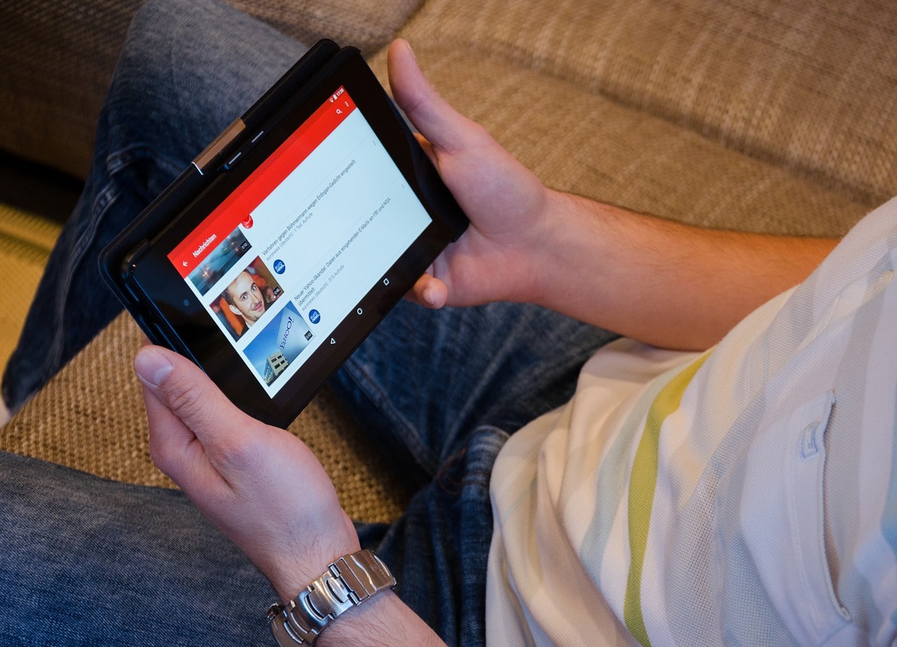 Man browsing youtube videos on tablet